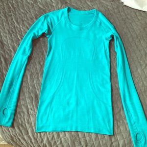 Lululemon size 2 long sleeve turquoise undershirt.